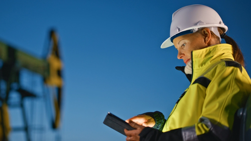 Stock image of Wireless Networks Mining worker on a mobile phone in high vis