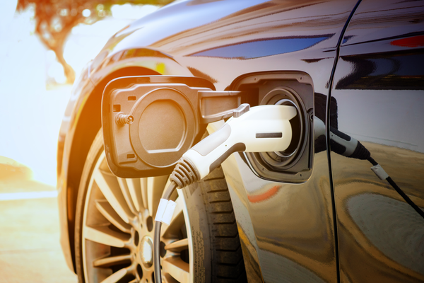 Charging port with charger on a black electric vehicle