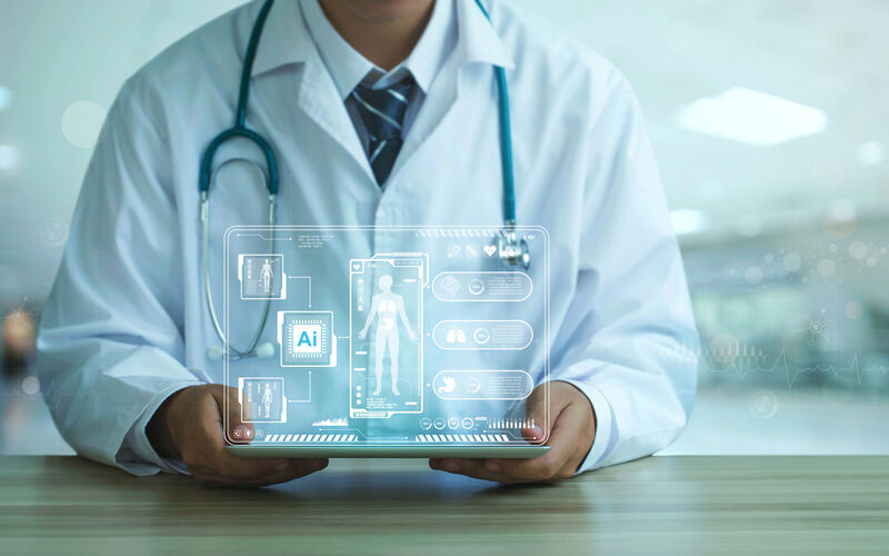 doctor holding tablet with graphics coming up showing medical and AI graphics