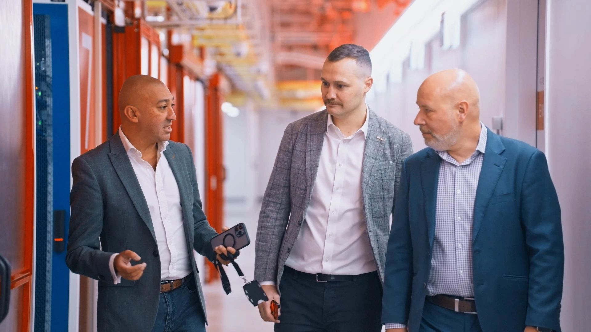 Experts from Vocus, Compnow, and NEXTDC discuss infrastructure modernisation during a tour of a NEXTDC data centre in Sydney.