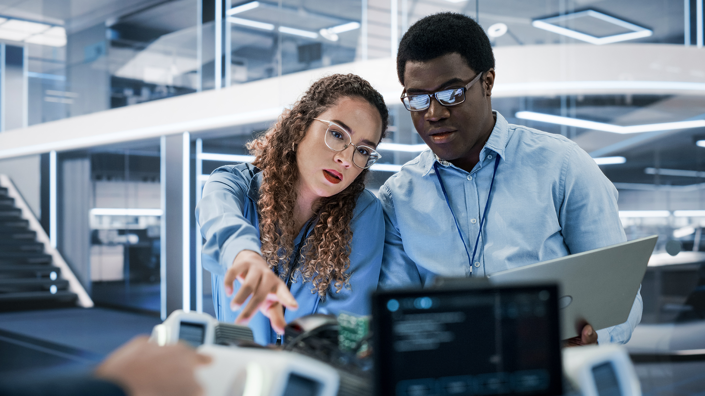 Two engineers working at a desk