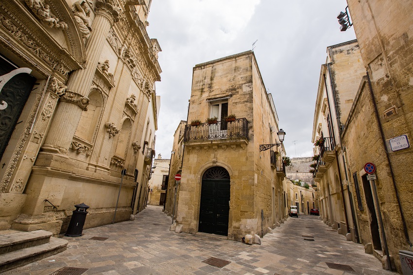 An empty stone street and historic stone buildings in Lecce, Italy