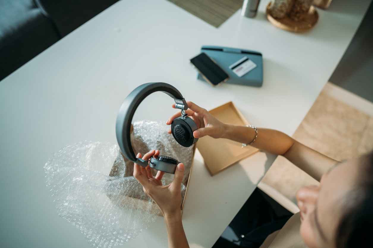 Woman Holding Headphones with TruExtent beryllium domes