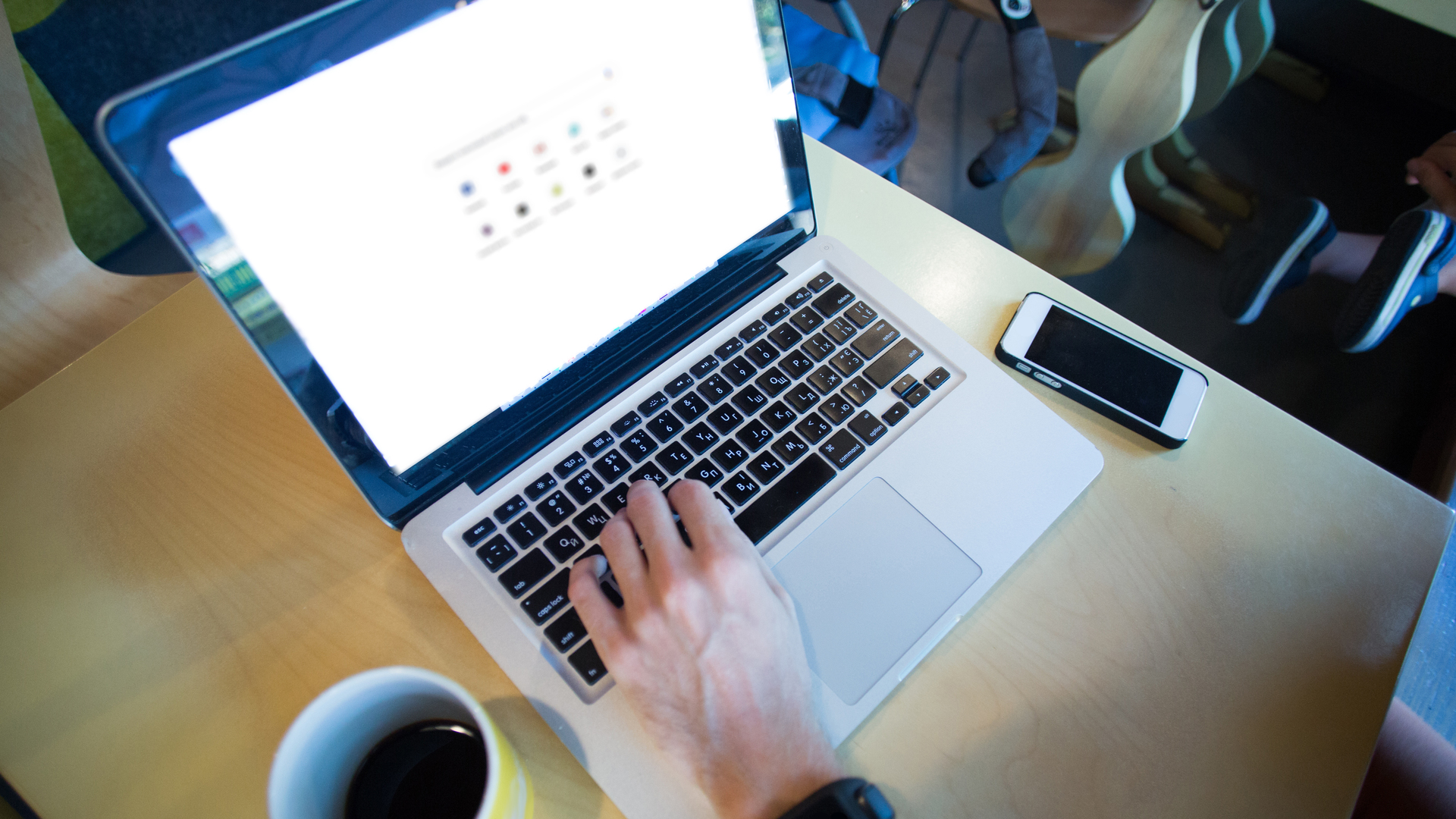 cropped view of man using laptop with google website on screen