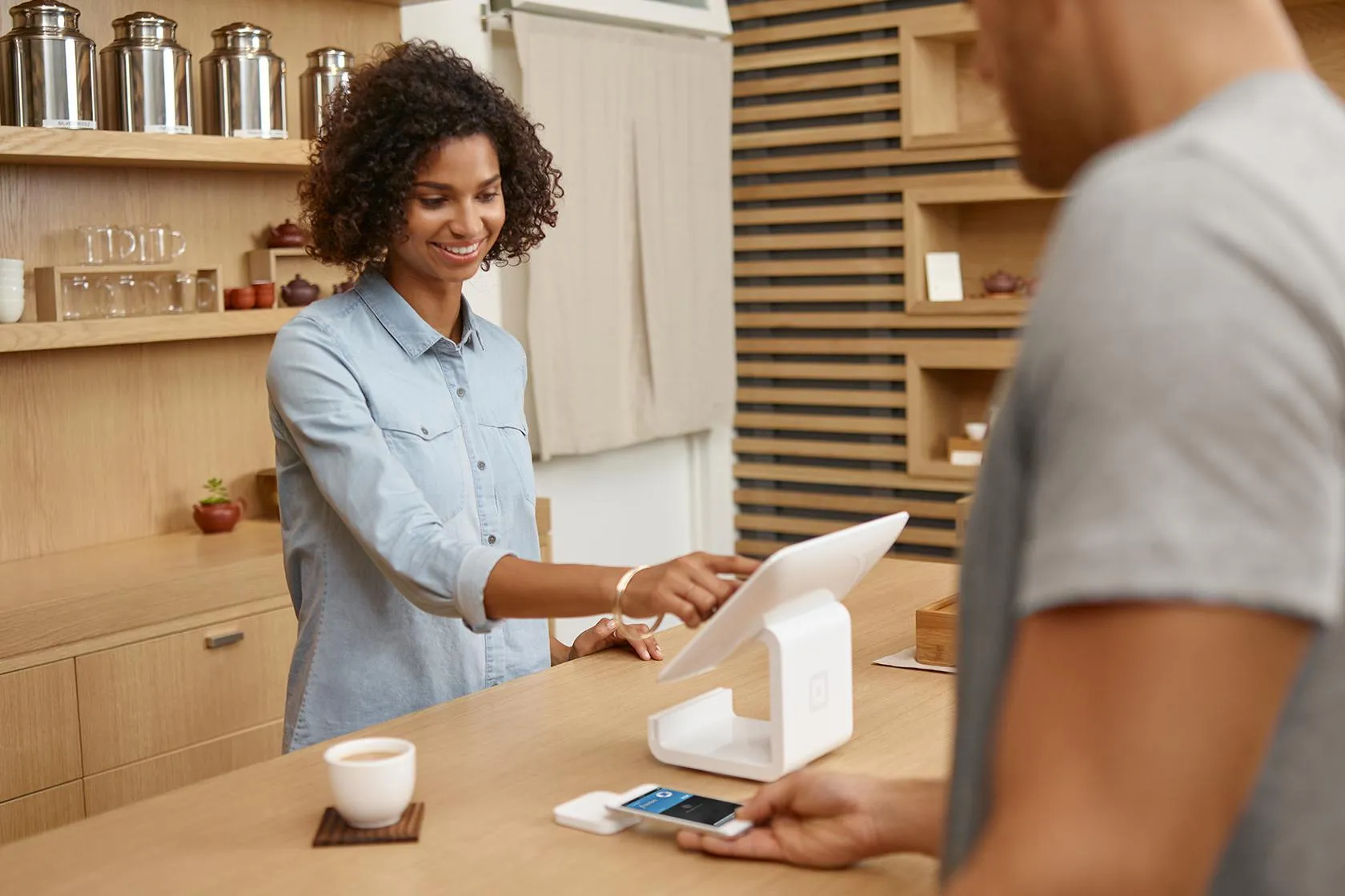 Man paying with Apple Pay at counter