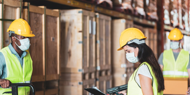 Diversity workers wear protective face mask in warehouse