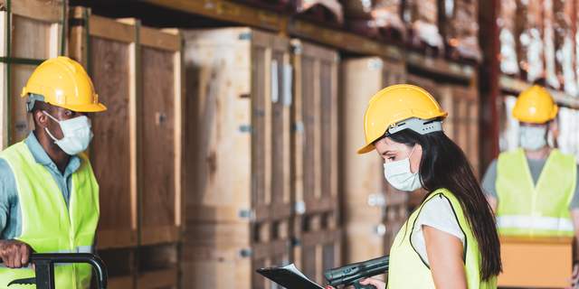 Diversity workers wear protective face mask in warehouse