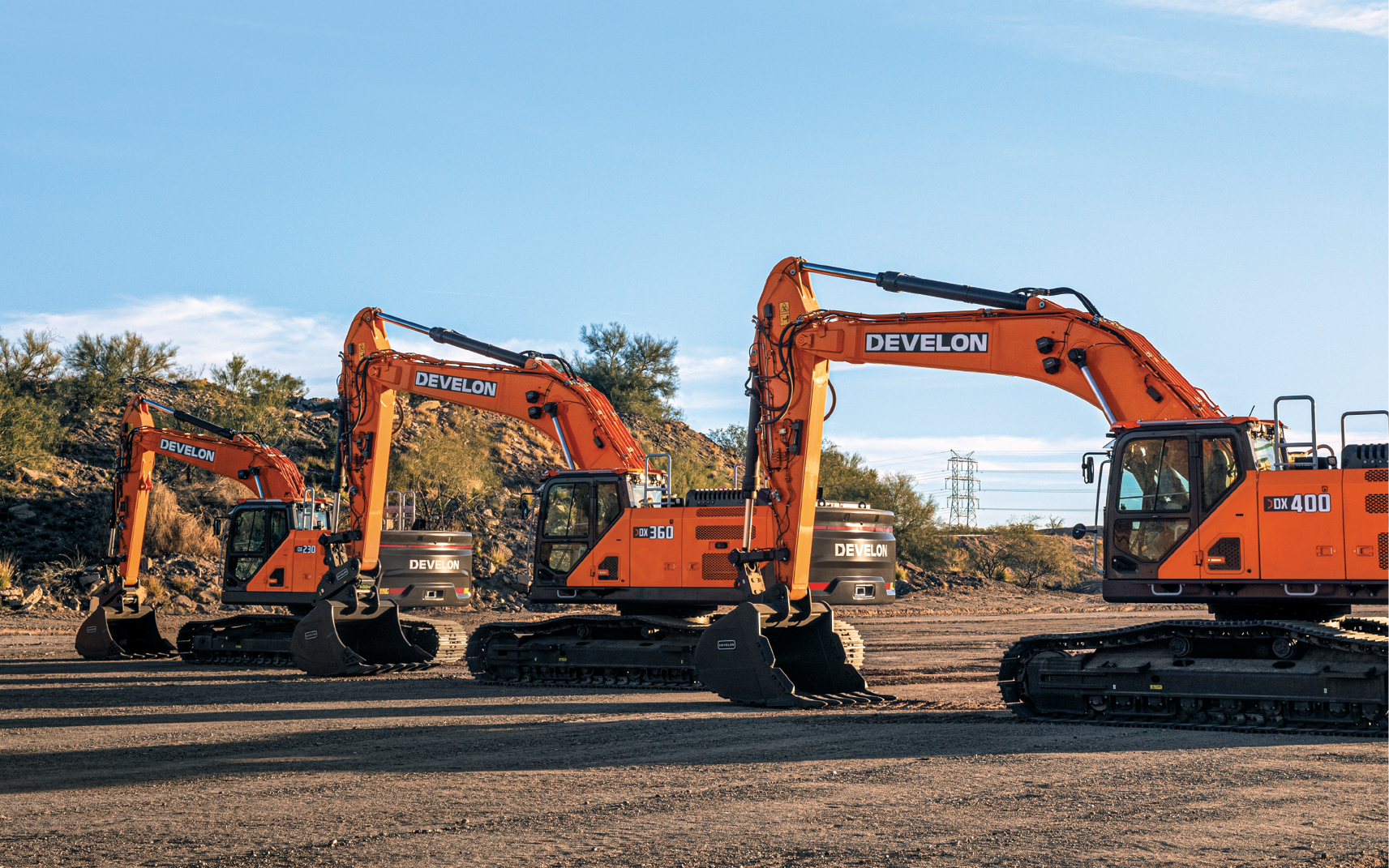 DEVELON DX230LC-9, DX360LC-9 and DX400LC-9 crawler excavators in a row on a jobsite. 