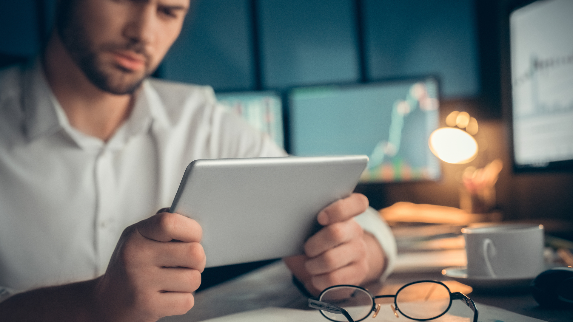 Man watching video or read the book at screen tablet