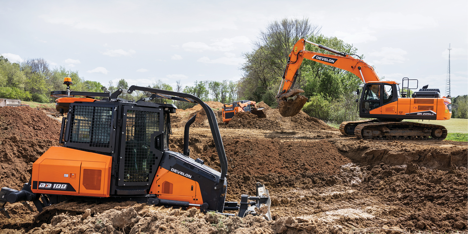 A DEVELON dozer and crawler excavator working on a job site