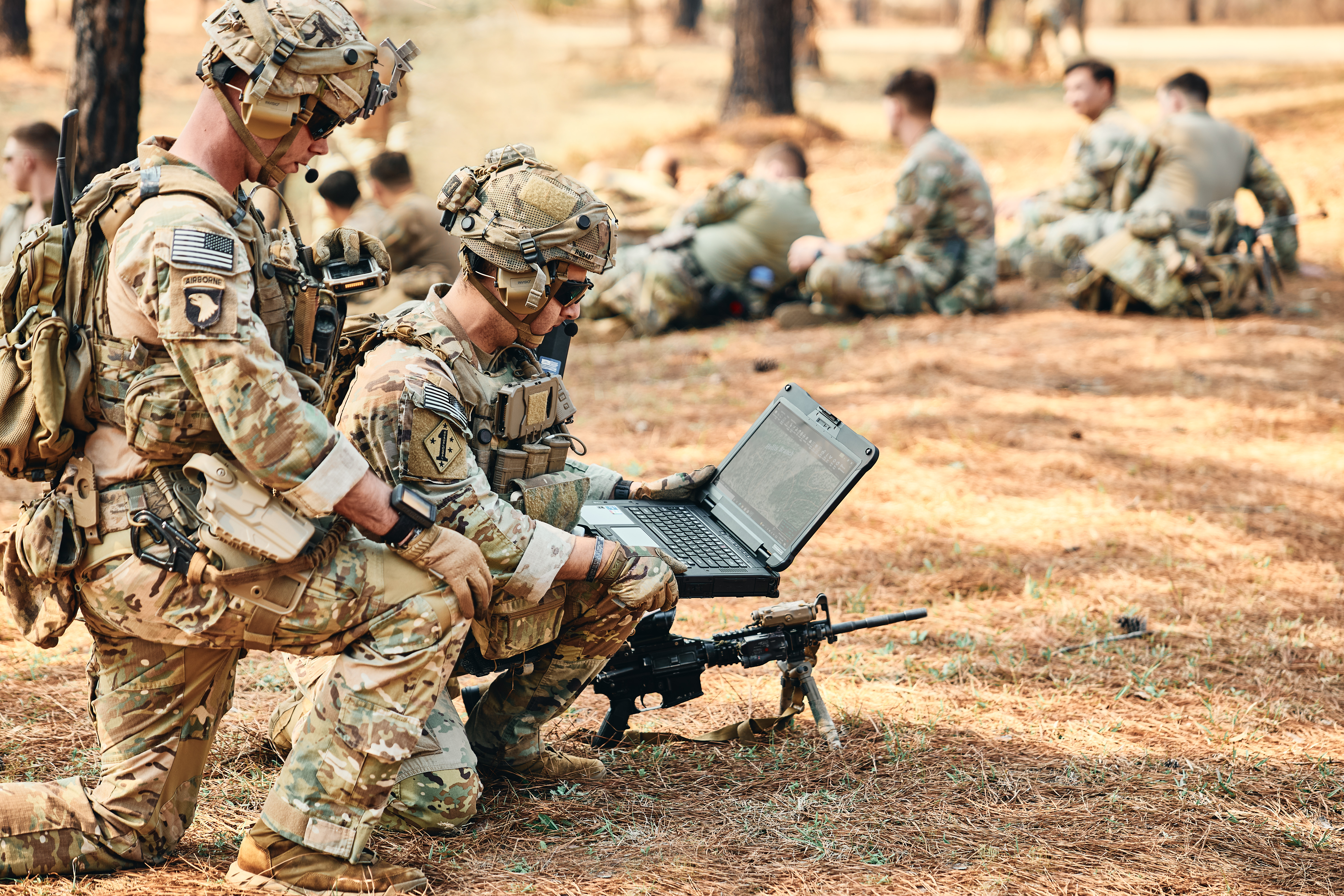 A soldier uses military technology in the field.