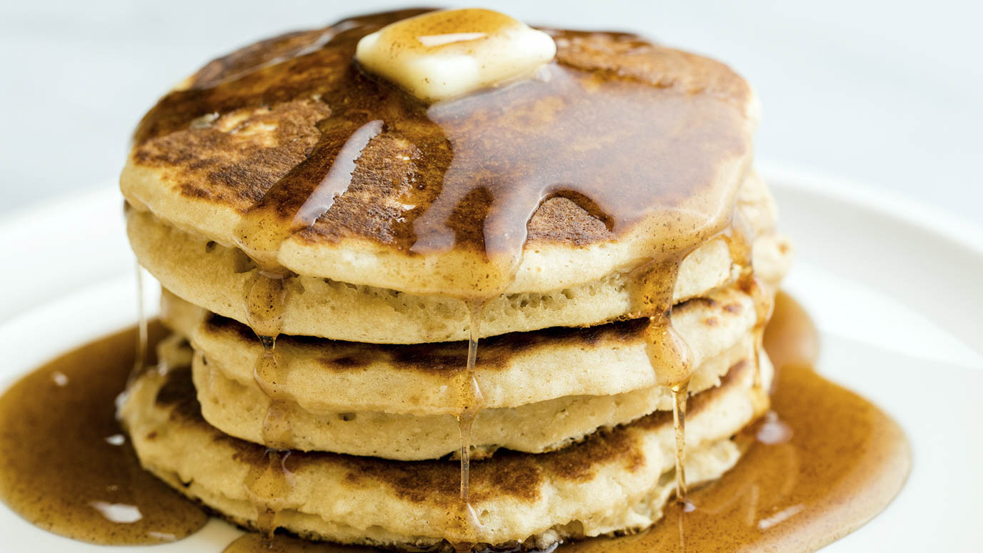 Pancakes covered in syrup and butter