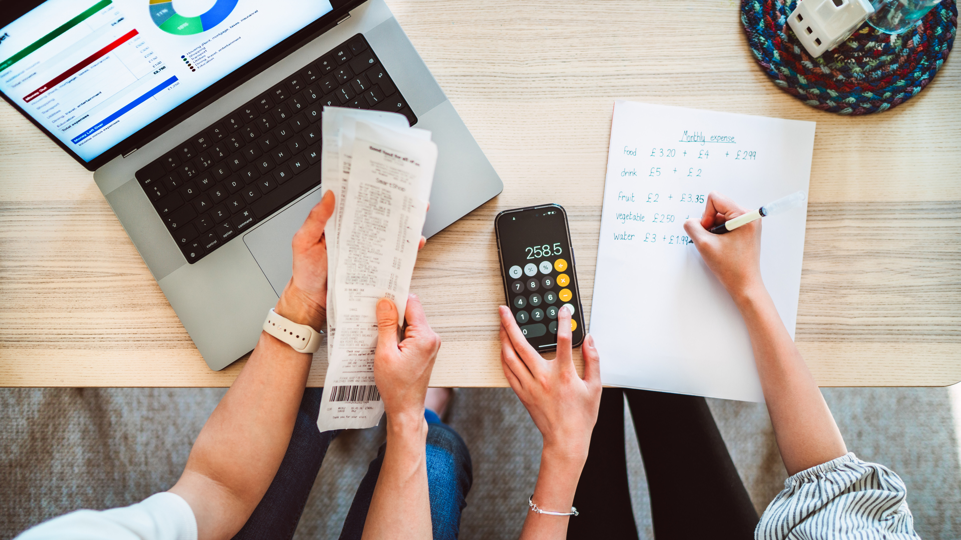 Direct above shot of Asian mom and daughter learning finance together at home