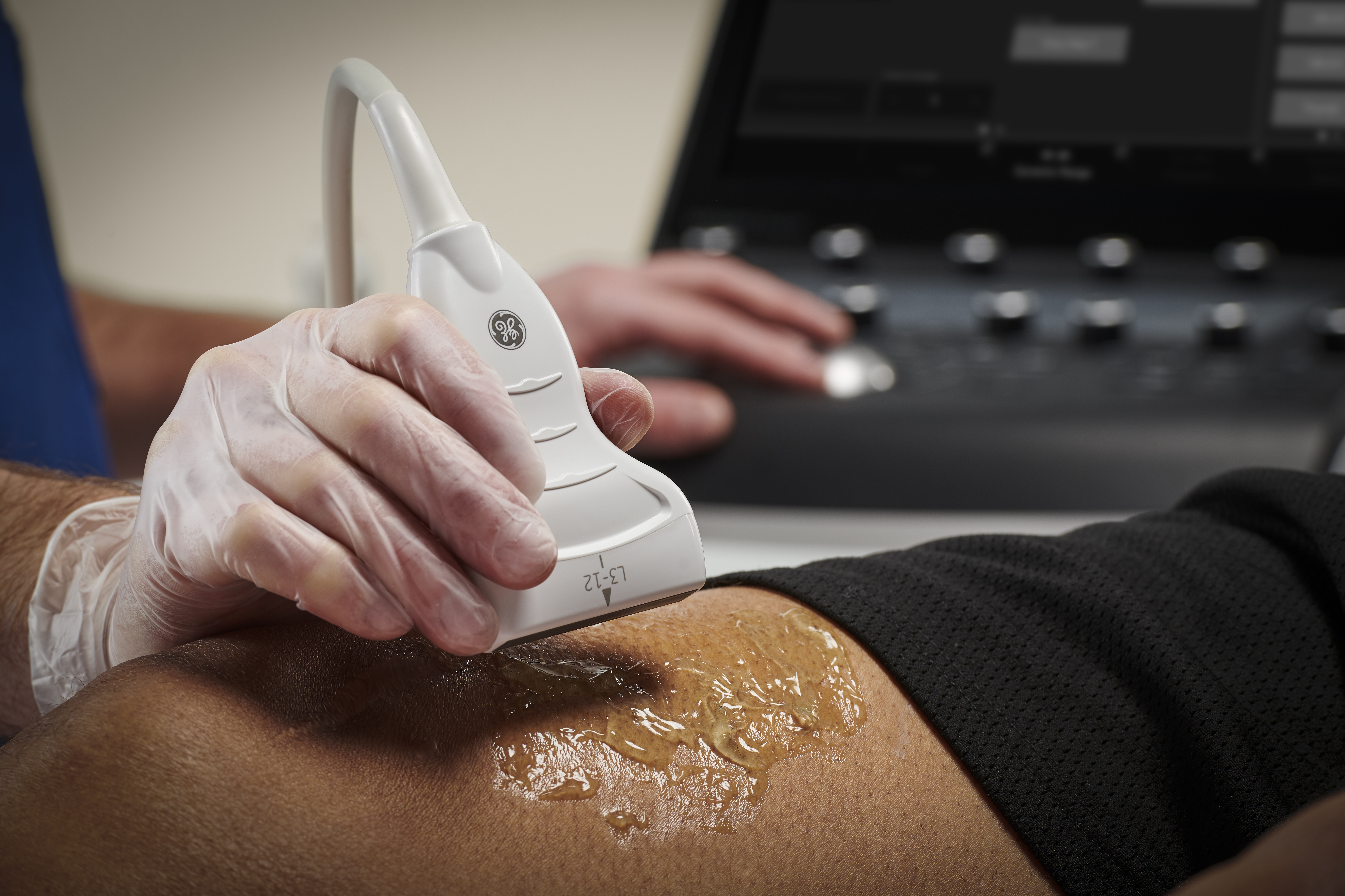 A doctor scans a patient using ultrasound