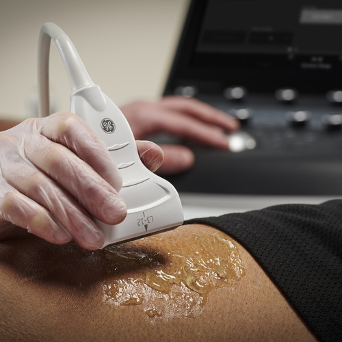 A doctor scans a patient using ultrasound
