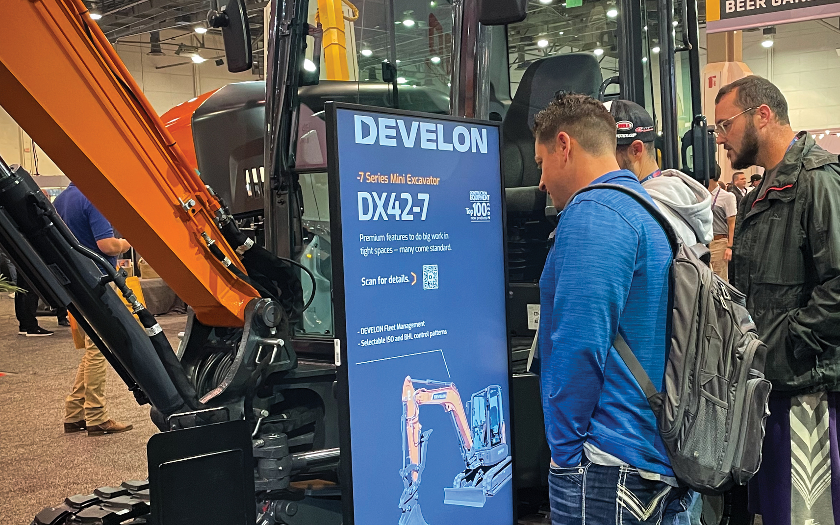 World of Concrete attendees check out the DX42-7 mini excavator in the DEVELON exhibit.