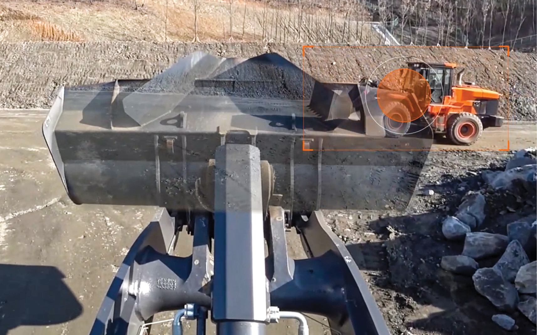 Operators can detect objects in front of the machine with the Transparent Bucket &ldquo;see through&rdquo; feature.