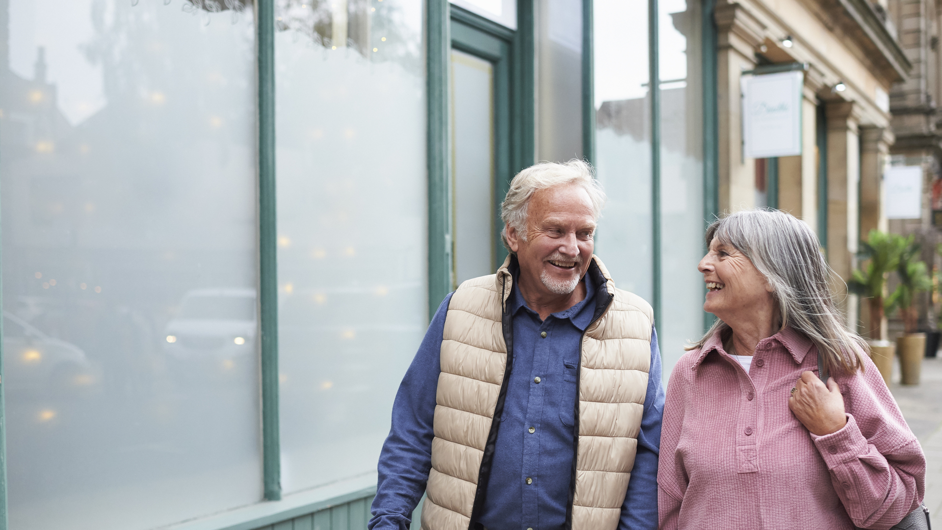 Happy senior couple walking on a city street