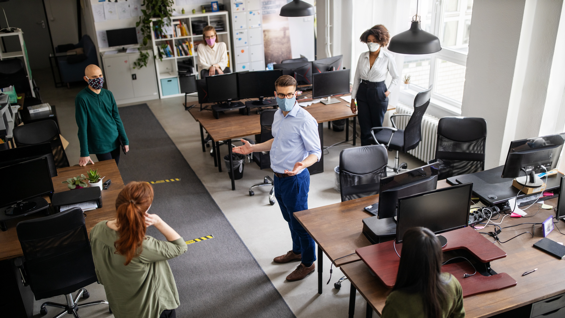 Staff meeting in office with social distancing