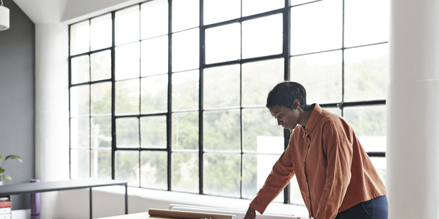 Entrepreneur working by table at workplace