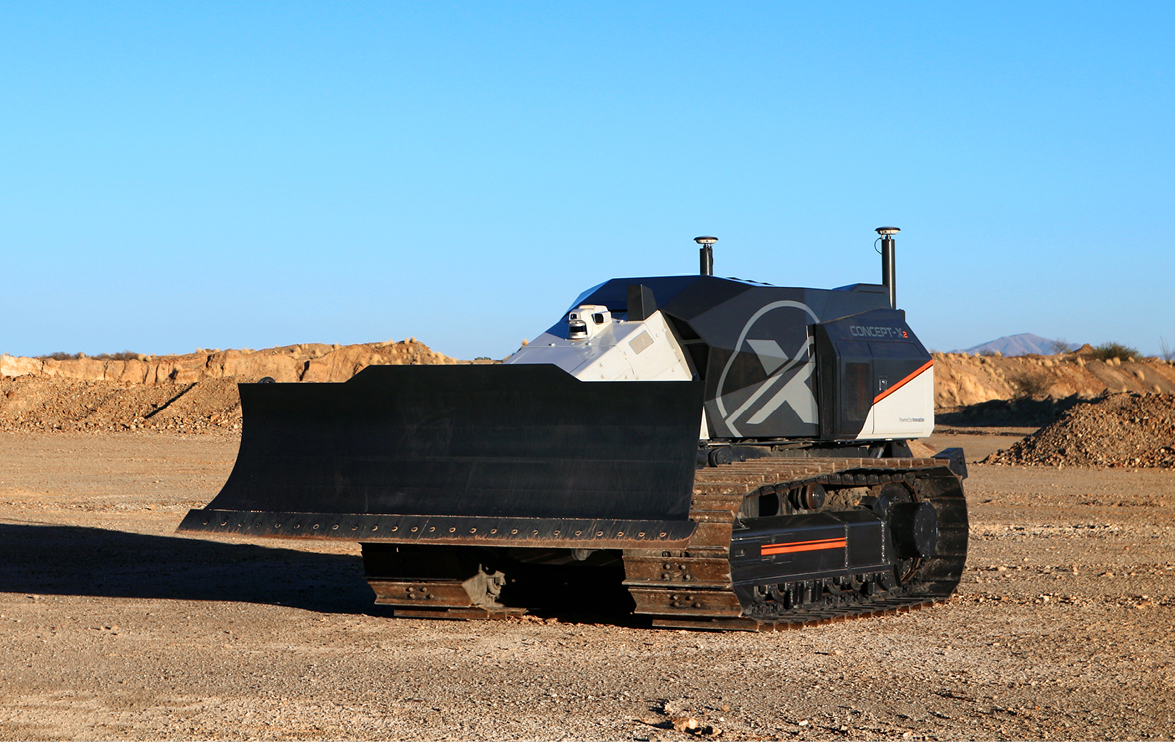 The DEVELON fully autonomous CX100 dozer driving on testing grounds.