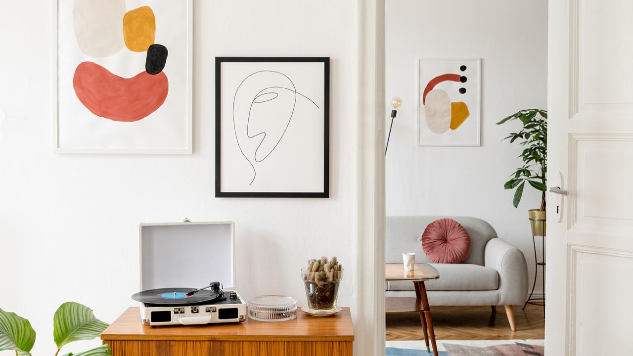 A room with a record player and artwork on the wallAI-generated content may be incorrect.
