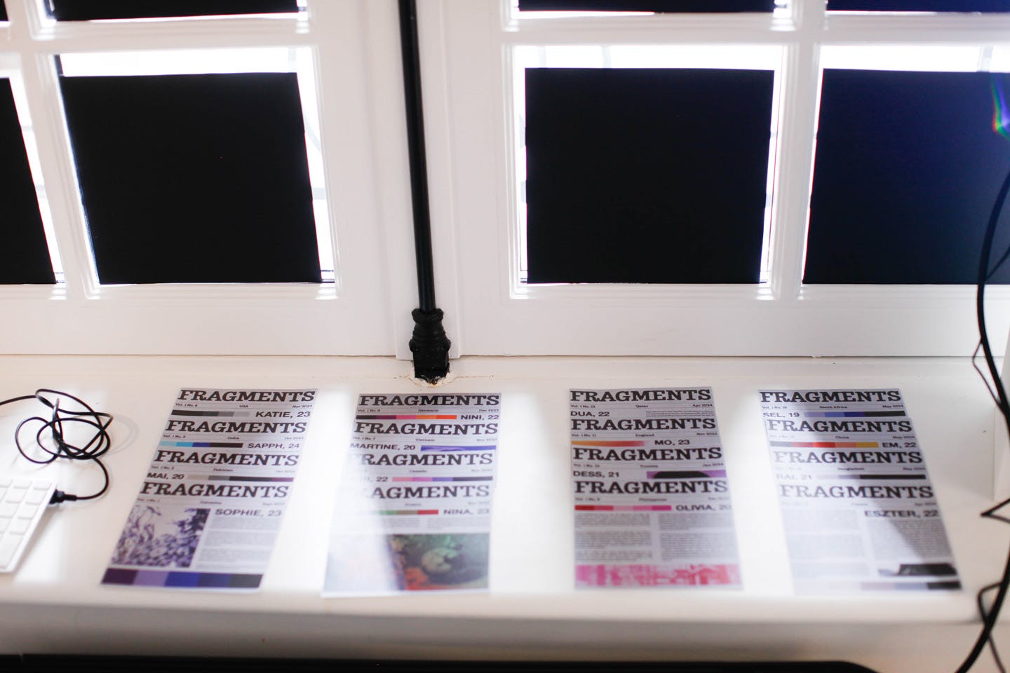 Printed “Fragments” zines displayed on a windowsill in natural light