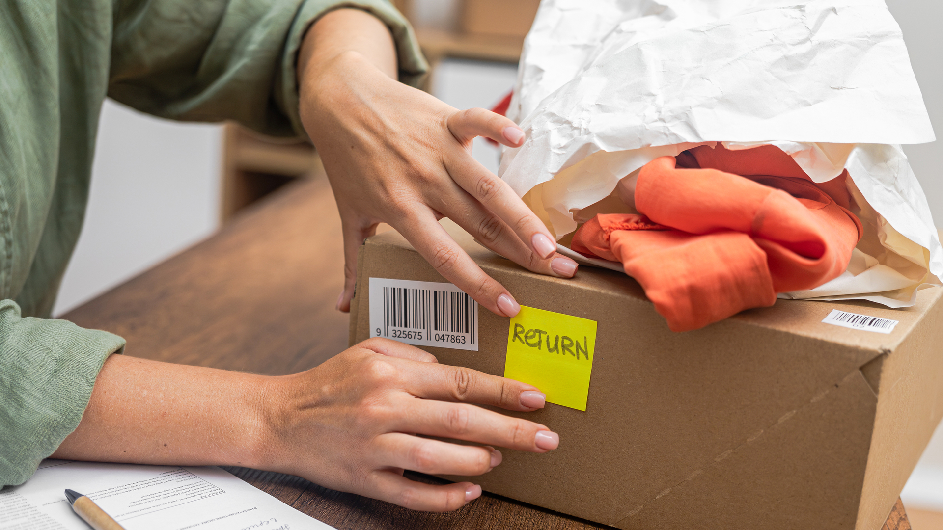woman online shopper affixes a barcode sticker to a cardboard box, marking it for return and refund.