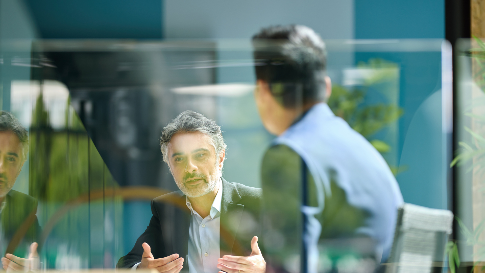 Medium shot of businessman discussing project with colleague