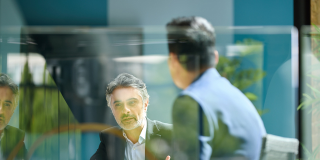 Medium shot of businessman discussing project with colleague