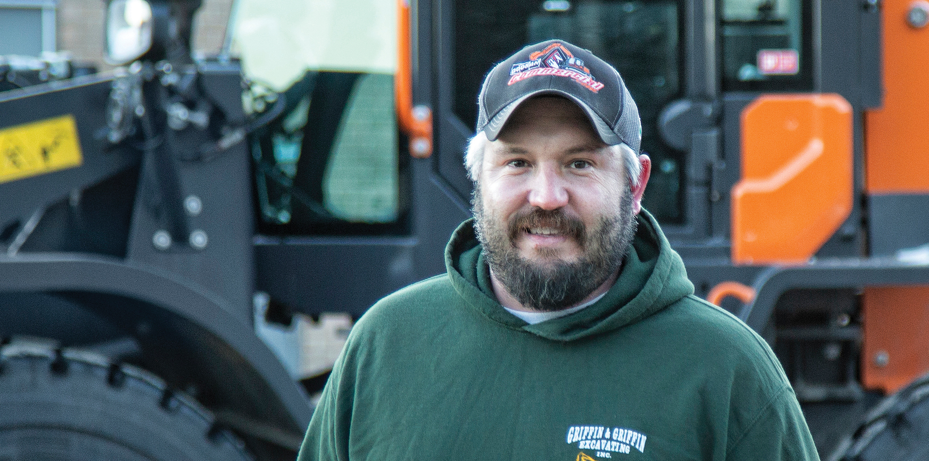 Chris Griffin of Griffin and Sons Excavating standing in front of his DEVELON machine.