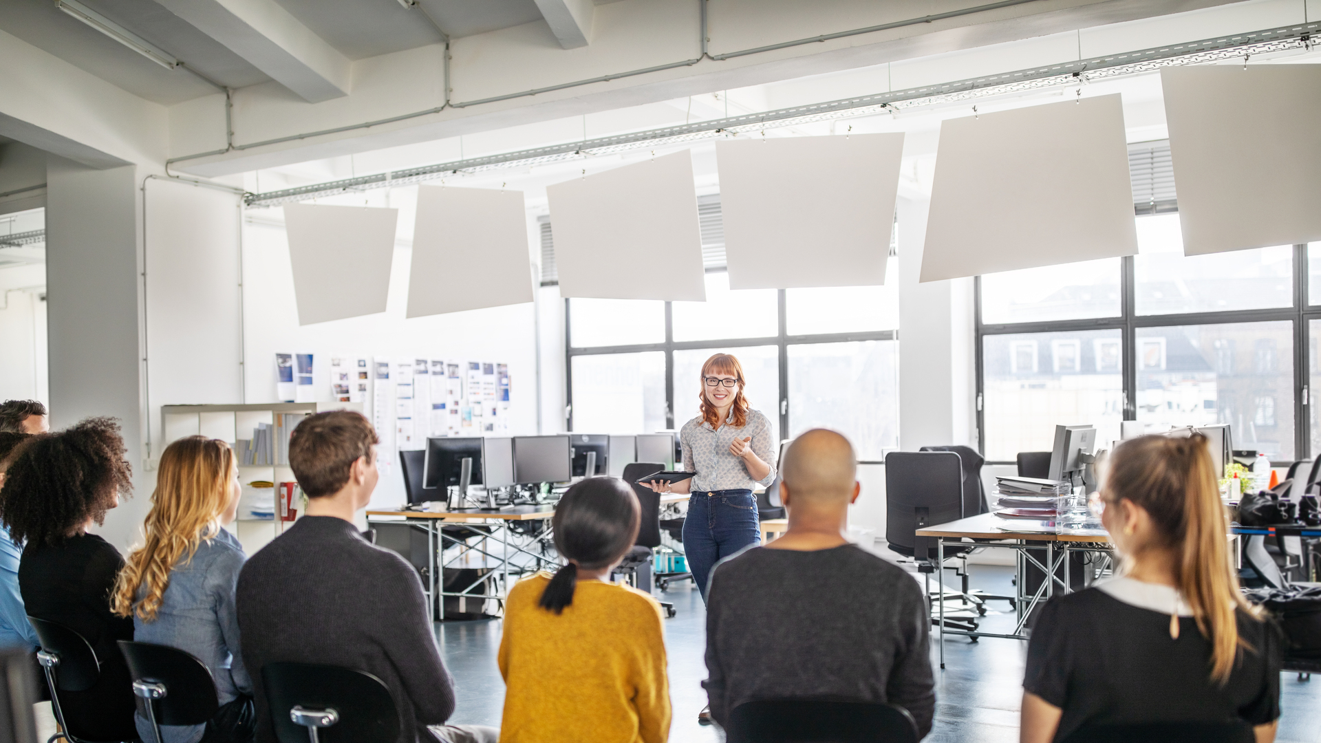 Young businesswoman addressing her team