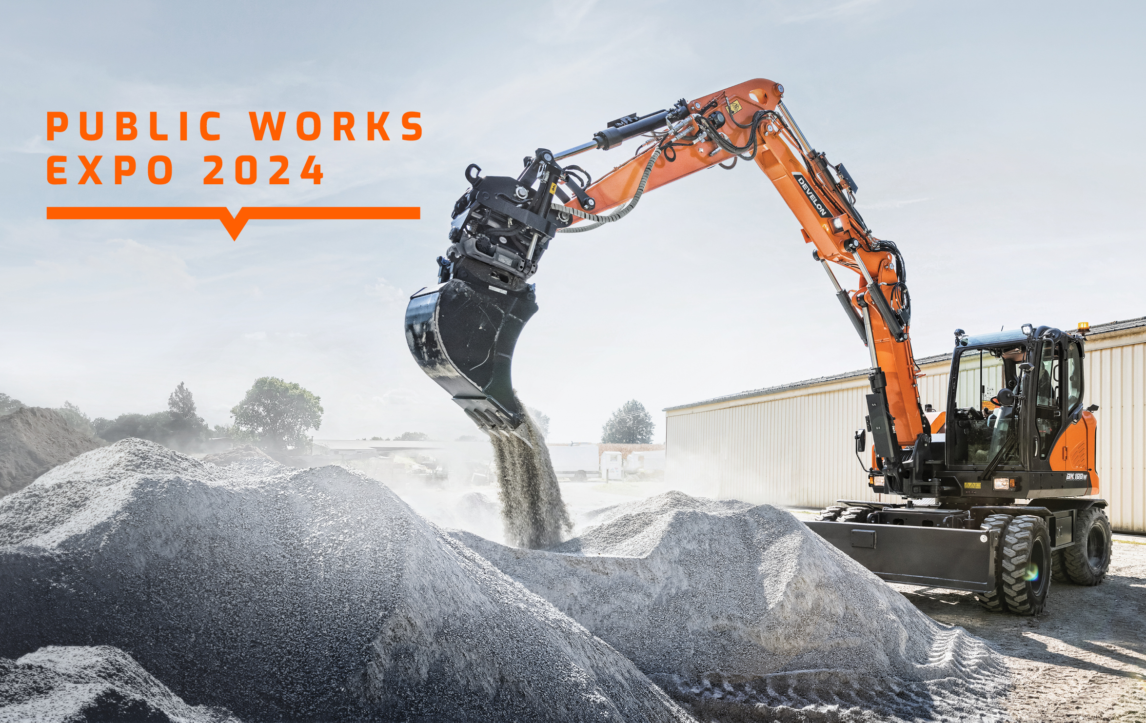 The DX100W-7 mini wheel excavator handles material underneath the DEVELON logo and Public Works Expo 2024 headline.