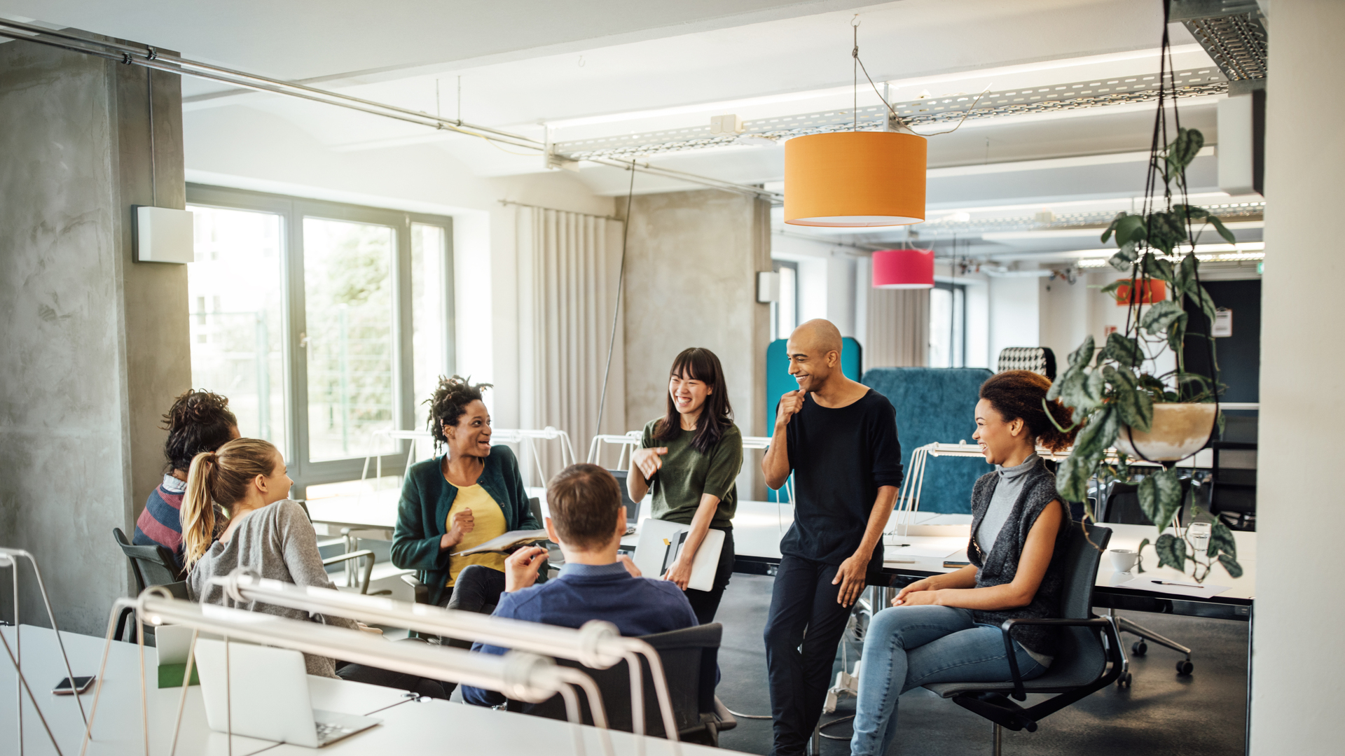 Happy multi-ethnic people discussing at office