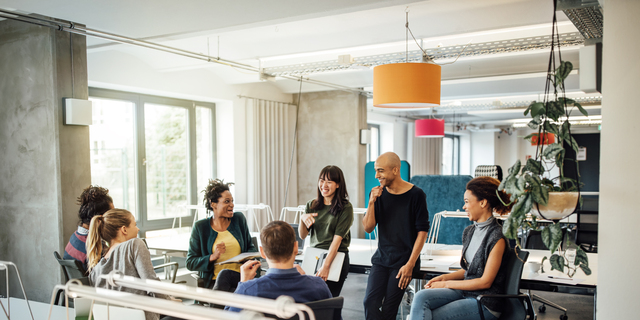 Happy multi-ethnic people discussing at office