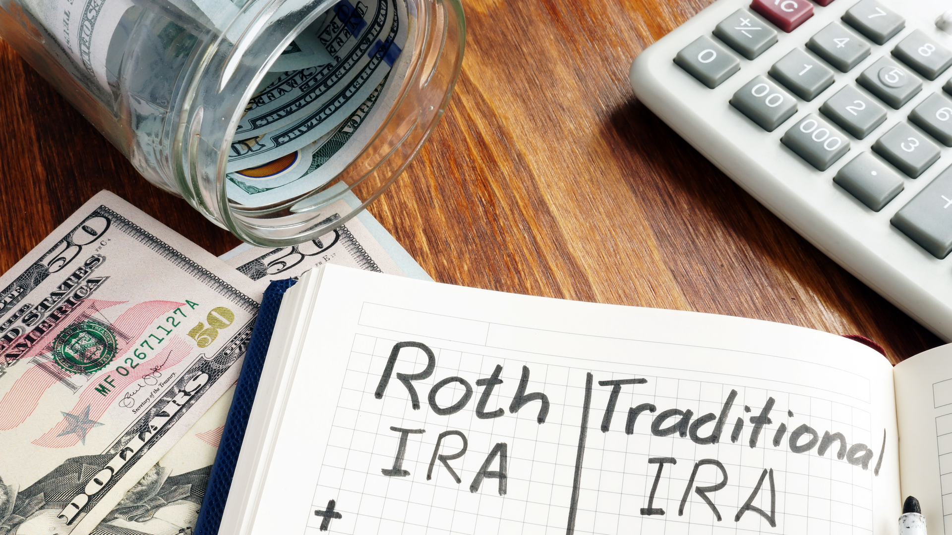 Roth IRA vs Traditional IRA written in the notepad.