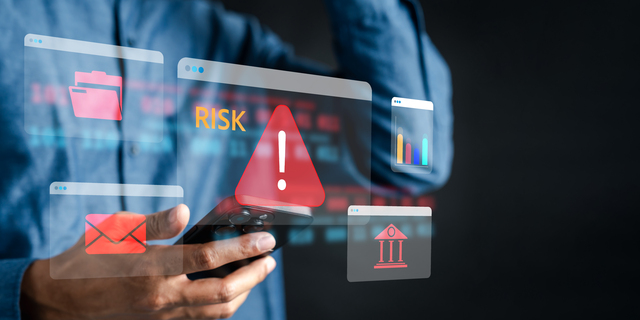 Financial risk and cybersecurity with red warning, risk alert message, and digital banking fraud, data breach, and online threats.