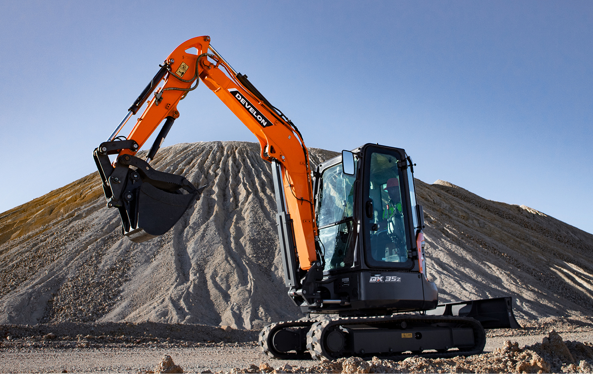 The DEVELON DX35Z-7 mini excavator works on a jobsite.