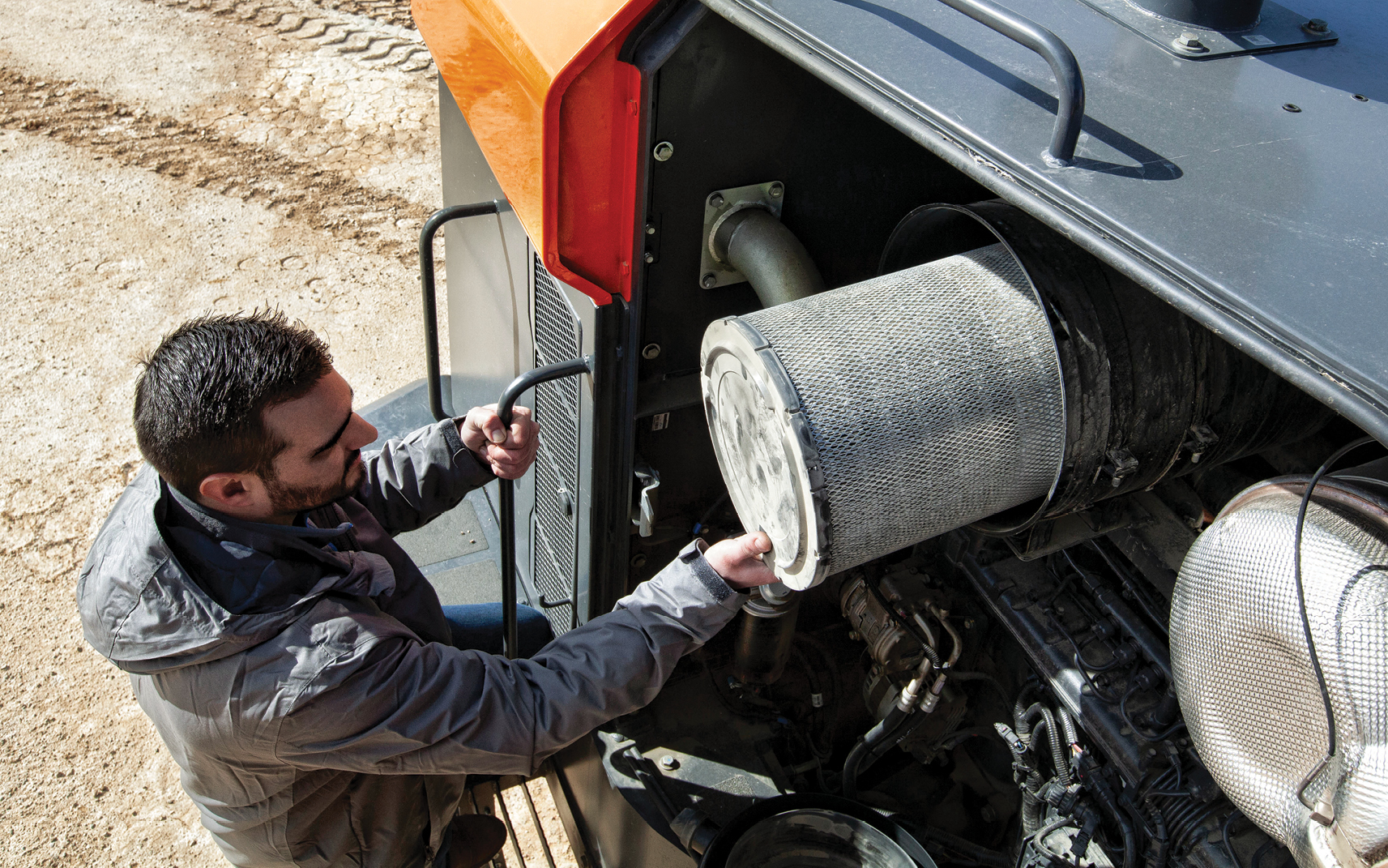 DEVELON technician replaces a heavy equipment filter.