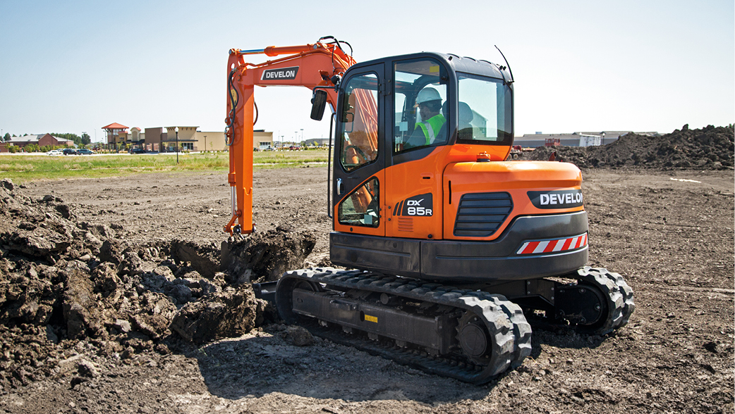 A DEVELON mini excavator working on a job site.