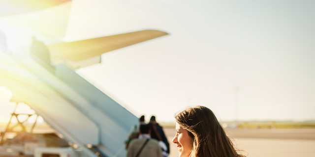 Pretty woman getting in to plane