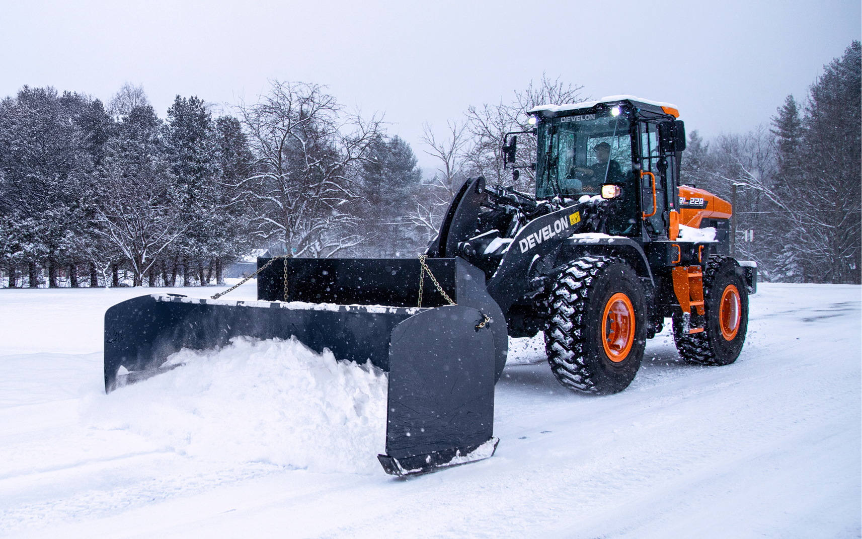 A DEVELON DL220-7P wheel loader pushing snow after following a winter prep checklist.
