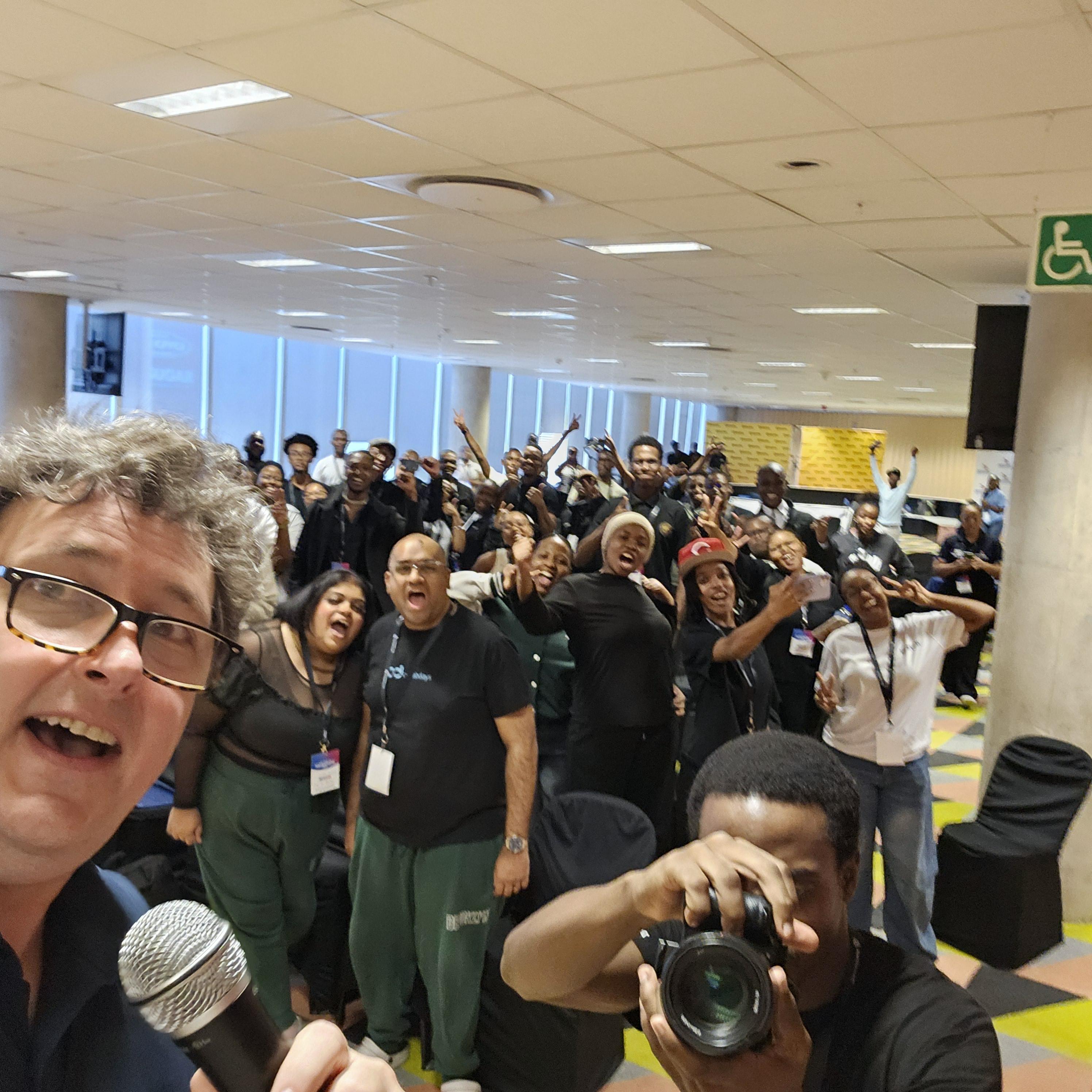 Selfie of James Stanger with group of learners