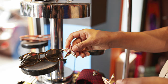 Woman placing accessories in store