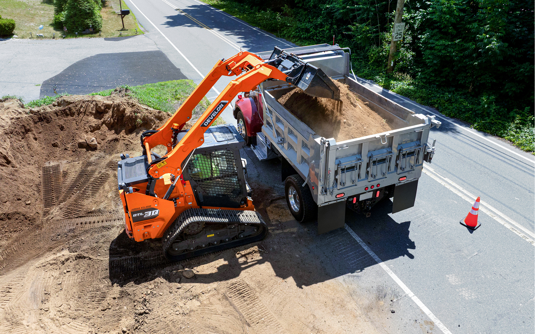 A DEVELON DTL30 CTL with DEF-free engine loading a truck with dirt.