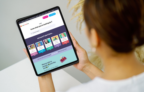 an ipad with a helpline website on it