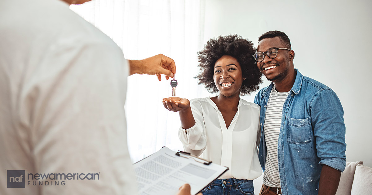 agent handing couple house keys