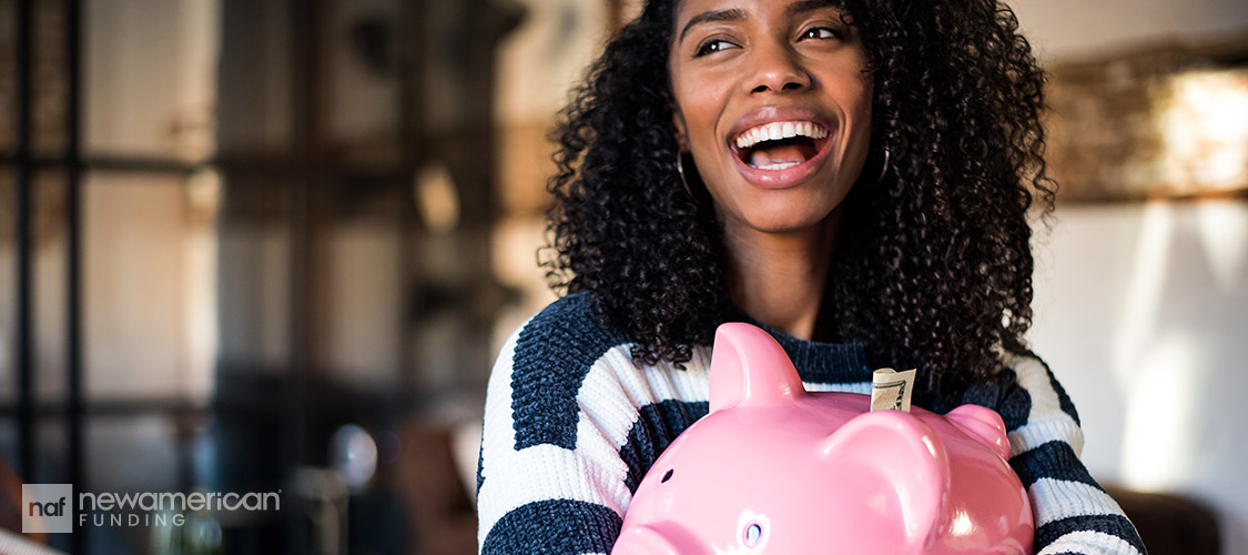 woman hugging a piggy bank