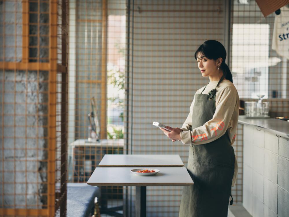 Restaurant owner using Square Handheld