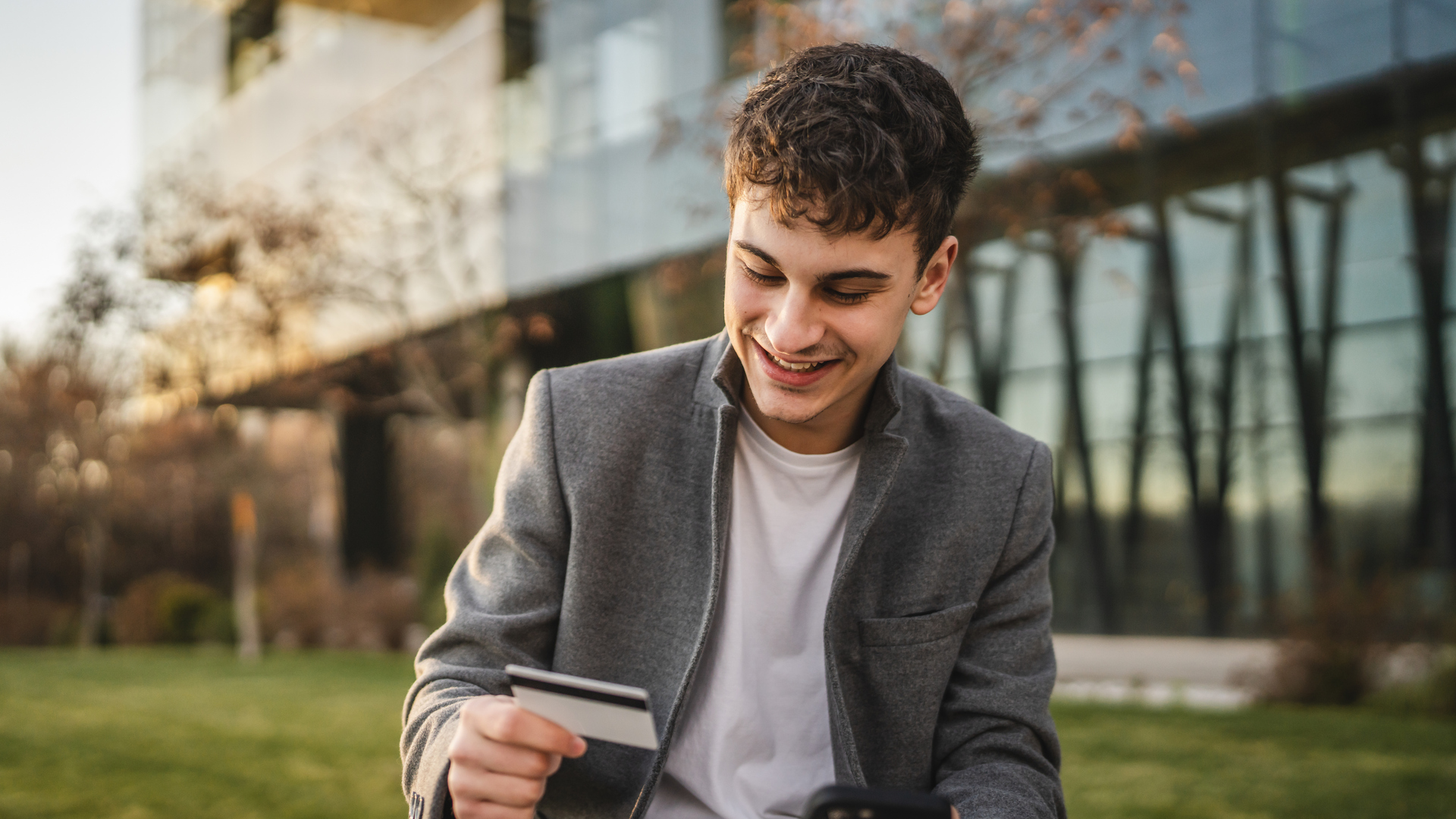 adult man use mobile phone and credit card for online shopping outdoor